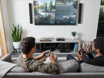 Two individuals on couch playing video games together.